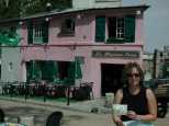 Lisa with the postcard of the Pink House, and the Pink House