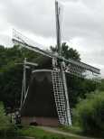 A thatch covered wind mill for grinding grains