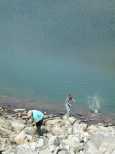 Dorian gives Caroline lessons in filling up the lake with rocks